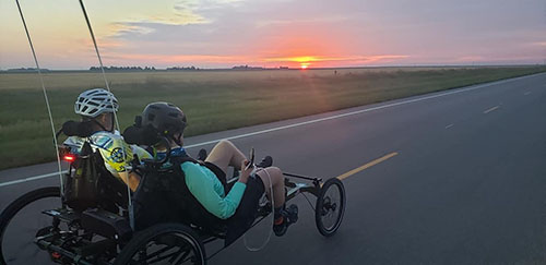 Josh and Mike on a recumbent bike for a 900-mile trek.